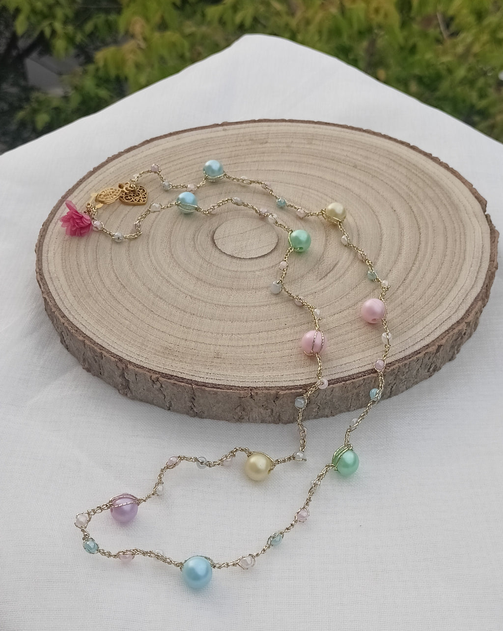 Pastel Doré collar artesanal con perlas nacaradas pastel sobre madera natural